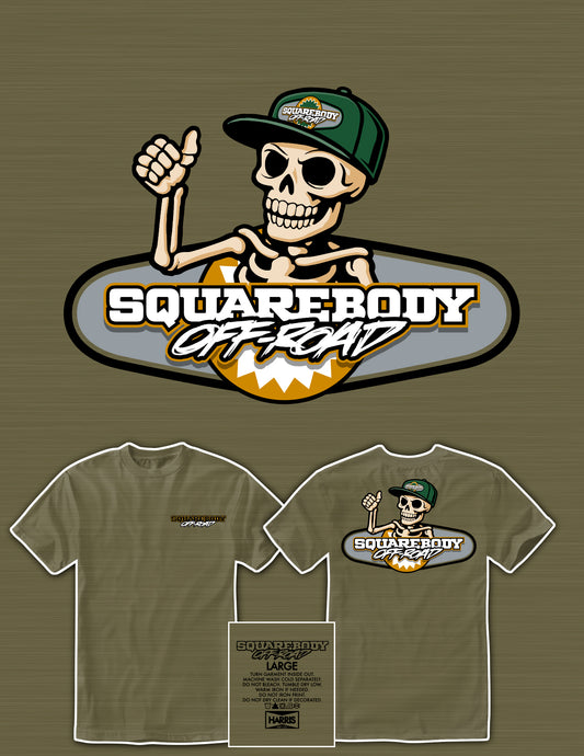 Squarebody Off Road logo with skeleton wearing a cap on a light olive t-shirt. 